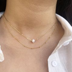 Gold Layered Necklaces, set of 2 necklaces - Goldfilled necklace with one natural pearl and a gold-filled chain necklace.2 separate necklaces so you can wear each necklace separately or together as a layered.Adjustable necklaces - each necklace comes with a 2" extension chain.♥ Necklaces length are 15 inches + 2" extension chain.If you wish for a different size contact us.♥ This necklace set is our recommendation for a Bridesmaid Gift.♥ Comes in a beautiful package ready for gifting. Dainty Pearl Chain Charm Necklace Choker, Dainty Pearl Chain Choker Necklace, Dainty Pearl Chain Charm Necklace, 14k Gold Filled Double Chain Necklaces For Layering, Minimalist Pearl Pendant Necklace For Layering, 14k Gold Filled Double Chain Necklace For Layering, Delicate Pearl Chain Necklace For Layering, Pearl Layered Necklace With Adjustable Chain As Gift, Pearl Charm Necklaces For Layering