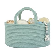 a blue basket filled with baby items on top of a white background