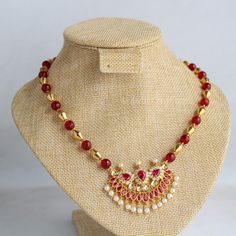 Beautiful fancy pendant with red and white stones studded. For string I have make combination of dholki gold beads and red beads. It gives elegant look. Length is 18 inches. Extra rings are attached. As this is my own design and made by me ,I will make changes according your choice. For any changes please message me. Festival Temple Jewelry Necklace With Pearl Chain, Festival Temple Necklace With Pearl Chain, Gold Ruby Round Bead Necklaces, Ruby Necklaces For Diwali Celebration, Gold Ruby Beaded Necklace, Gold Ruby Necklace With Round Beads, Gold Ruby Jeweled Necklaces, Gold Necklace With Round Ruby Beads, Gold Beaded Ruby Necklace