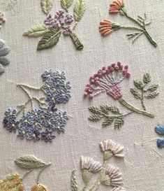 several different types of embroidered flowers on fabric