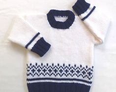 a white sweater with blue and white designs on it