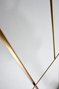 the ceiling is white and has gold lines on it, along with two poles that are connected to each other