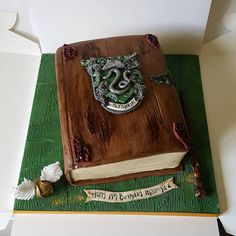 a harry potter book cake on top of a green mat