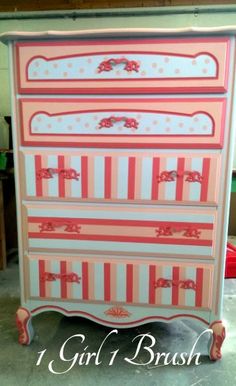 an old dresser painted in pink and white stripes