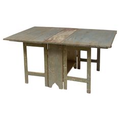 an old wooden table with two different pieces of wood at the top and one section missing