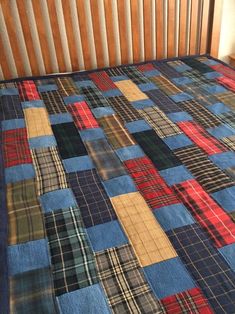 the bed is made up with many different plaid patterns