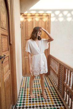 The stunning embroidered crochet in our Venice robe sets the scene for a relaxing getaway. Designed for the wanderlust-inspired woman in embroidered cotton with crochet oversized floral details, a dolman sleeve silhouette, side slits, and a tassel waist tie. This breezy robe brings delicate texture to your resort look - making it a lovely pick for your wedding day, honeymoon, leisure weekend hours by the pool or beach, and beyond.  Just add flats or sandals to this dainty robe for a look that takes you from brunch with friends to dinner and drinks with ease.  One size fits most. Comfortably fits those who are between a size X-Small to Large and all body shapes. Visit our site to see the entire collection: girlandaseriousdream.com  Images by D'Arcy Benincosa. Bridal Party Robe, Embroidered Crochet, Embroidered Robes, Resort Look, Sleeve Silhouette, Bridal Party Robes, Bridal Shower Gift, Womens Robes, Lace Hem