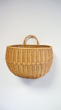 a wicker basket hanging on the wall