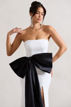 You're a gift. so you should dress like it. Sincerely arrives in a premium cotton blend boasting a curve-enhancing silhouette and boned corset bodice for extra support. Defined by an extravagant black bow attached to the front. this white maxi is perfect for any black tie event you have coming up. Style yours with our Catcher heels for the perfect match. Features - Premium cotton blend- Bandeau neckline- Boned corset bodice- Invisible zip closure - Oversized black satin bow- High leg split- Maxi Velvet Prom Dress, White Bandeau, Bachelorette Party Outfit, Ruched Maxi Dress, Black Tie Gala, Leg Split, Corset Bodice, Split Maxi Dress, Black Tie Event