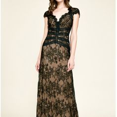 a woman in a long dress with black lace on it