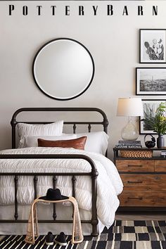 a bedroom with a bed, dresser and pictures on the wall above it that says pottery barn