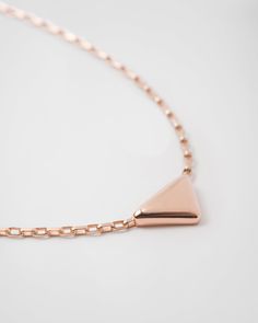 750 Pink Gold (18 kt) Triangle pendant: 1.66 cm (0.65 inches) Lobster claw clasp with logo-engraved medal Length: 45 cm (17.71 inches) adjustable to 43 cm (16.92 inches) and 41 cm (16.14 inches) Made in Italy Each step of Prada's responsible gold and diamond production chain is verified and traceable thanks to Aura Blockchain technology. Pink Gold Necklace, Mens Holiday, Mens Travel, Triangle Pendant, Triangle Logo, Women Essentials, Fine Jewelry Collection, Blockchain Technology, High Jewelry