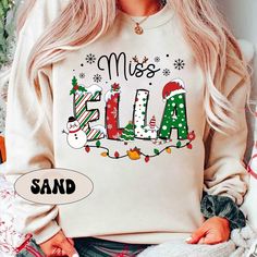 "Personalized Christmas Teacher Shirt, Xmas Teacher Name Shirt, Teacher Christmas Sweatshirt, Xmas Teacher Pattern, Christmas Teacher Gift ↓ Click here to view our additional fashionable collections ↓ https://handcraftedbyhelenn.etsy.com Product Details: - 100% Cotton (fiber content may vary for different colors) - Medium fabric (5.3 oz/yd2 (180 g/m2)) - Classic fit - Tear away label - Runs true to size Care instructions: - Machine wash: warm (max 40C or 105F); - Non-chlorine: bleach as needed; Personalized Teacher Christmas Gifts, Teacher Christmas Sweater, Teacher Team Christmas Shirts, Teacher Pattern, Christmas Teacher Gift, My Favourite Teacher, Teacher Christmas Gifts, Teacher Name, Teacher Christmas