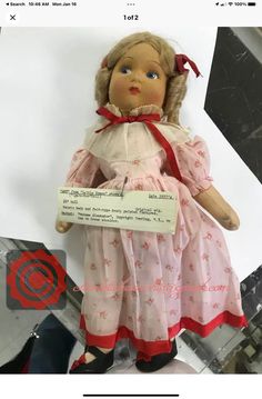 an old fashioned doll is on display for sale