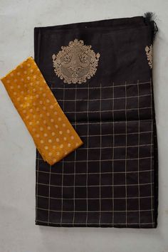 The charm of this black silk Banarasi saree is sure to leave everyone awestruck! It is enhanced with zari motifs border and comes with a yellow blouse piece. Disclaimer: The shown stitched blouse on the model is for display purpose only. The saree comes with a matching blouse piece and finished with fall and piko. DISCLAIMER: The actual product may vary slightly from the image. These are custom orders, hence expect slight variation in color and placement of the motif or buta. ESTIMATED DELIVERY: Black Unstitched Suit With Pallu For Diwali, Black Churidar With Pallu For Diwali, Black Churidar With Pallu In Traditional Drape, Black Tussar Silk Traditional Wear With Self Design, Black Banarasi Silk Sets With Zari Work, Black Katan Silk Blouse Piece With Self Design, Black Traditional Churidar With Pallu, Semi-stitched Black Set For Puja, Black Raw Silk Traditional Wear For Puja