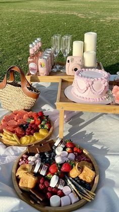 two trays filled with food sitting on top of a white table covered in grass