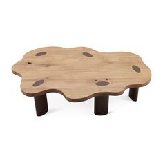 a wooden table with black legs and brown dots on the top, in front of a white background