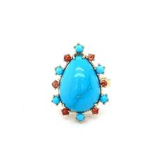 This ring has a 9.67 Carat Pear Cut Turquoise and is surrounded by 6 Round Cut Orange Sapphires that weigh 0.38 Carats and 6 Turquoise stones that weigh 0.52 Carats. The total carat weight of the ring is 10.57 Carats. The ring is crafted in 14 Karat Yellow Gold and weighs 7.7 grams. The ring is a size 7  The Turquoise are natural and mined in Persia. This Turquoise has some natural visible inclusions that gives this piece a very authentic and antique type look.  Exact dimensions for this item ar Turquoise Oval Multi-stone Opal Ring, Luxury Blue Multi-stone Turquoise Ring, Turquoise Multi-stone Ring Fine Jewelry, Fine Jewelry Turquoise Multi-stone Ring, Turquoise Rings With Gemstone Accents In Fine Jewelry Style, Oval Blue Multi-stone Turquoise Ring, Turquoise Ring With Gemstone Accents Fine Jewelry, Turquoise Fine Jewelry Ring With Gemstone Accents, Yellow Gold Cocktail Ring