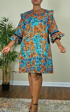 This beautifully crafted kaftan dress features a colorful colorblock pattern, with asymmetrical Ruffles sleeves and a unique button accent. The dress has a round neckline and is closed with a button, making it perfect for a variety of occasions such as travel, weddings, parties, casual or formal events, and workwear.  The dress is made from high-quality polyester material, which is machine washable for easy care. It's available in size M, and L and is handmade, perfect for women who appreciate u Multicolor Mixed Print Dress For Vacation, Bohemian Multicolor Bell Sleeve Dress, Blue Mixed Print Dress, Multicolor Mixed Print Vacation Dress, Multicolor A-line Shift Midi Dress, Multicolor Patchwork Tunic Dress, Casual Multicolor Bell Sleeve Dress, Casual Blue Mixed Print Dress, African Dress Patterns