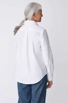 With a tailored look yet an ease of fit, our Box Pleat Ginna shirt is made for women on the move. A unique single piece collar construction can be worn up or softly folded befitting your mood. Back box pleat, center front exposed button closure, classic cuff length, sleeve placket detail, and signature loop detail. - 83% Cotton, 14% Polyamide, 3% Elastin - Made in NYC - Dry clean or machine wash - Our model is 5'9.5" wearing size 4 - Chest Width 40", Hip Width 45", Length 28" Orders are processed within three business days (not including weekends or holidays). All pre-orders are charged at the time of purchase and shipped on the date indicated on each style. All returns are subject to a per order restocking fee. Please visit the RETURNS/EXCHANGES page to review our policies regarding retur White Blouse With Concealed Placket And Fold-down Collar, Timeless Tops With Fold Down Collar And Placket, Timeless Tops With Placket And Fold-down Collar, Timeless Spread Collar Top For Daywear, Timeless Daywear Top With Spread Collar, Timeless Top With Spread Collar For Daywear, Classic Blouse With Relaxed Fit And Fold Down Collar, Modern Tops With Fold Down Collar And Placket, Modern Tops With Placket And Fold Down Collar