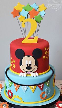 a mickey mouse birthday cake with stars on top