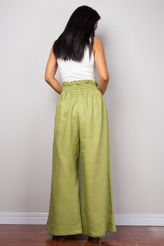 "Green Linen trousers, Handmade long wide leg palazzo pants with pockets. Green high waist women's summer linen pants, natural linen pants Made with the highest care this beautifully crafted high waist women's summer pants will fit you perfect thanks to the elastic strap on the waist and the added drawstring. I like wearing this one when sitting in the garden reading a book and dream away. Soul of the Orient Collection - Original Design & Produced by NUICHAN PRODUCT SIZE : * Waist : elastic Non-stretch Summer Harem Pants, Bohemian Summer Pants In Solid Color, Baggy Wide Leg Pants With Elastic Waistband For Beach, Non-stretch Linen Harem Pants For Spring, High-waisted Harem Pants For Summer, Solid High-waisted Harem Pants For Summer, Green Wide Leg Pants For Summer, Solid Color Summer High-waisted Harem Pants, Bohemian Summer Pants