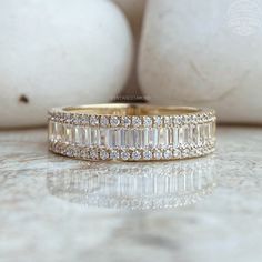 an image of a wedding band with baguettes on the side and diamonds in the middle