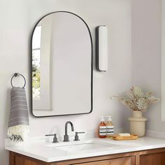 a bathroom sink with a mirror above it