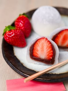 strawberries and ice cream on a plate with chopsticks