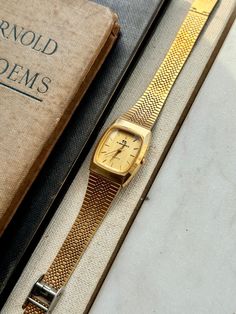 Gold Watches With Bracelet Strap And Rectangular Dial, Gold Rectangular Analog Watch, Gold Watch With Bracelet Strap And Rectangular Dial, Gold Jewelry Watch With Rectangular Dial And Bracelet Strap, Gold Analog Watch With Rectangular Face, Gold Rectangular Analog Jewelry And Watches, Rectangular Gold Analog Watch, Gold Watches With Rectangular Metal Dial, Women Wrist Watch