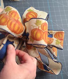 someone is making a pumpkin bow with fabric