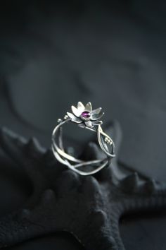 ITEM DESCRIPTION: The size of ring 6 3/4 (US and Canada) N 1/2 (UK and AU) I can make it any size you want - just mark your size in the order And you can order this lotus ring with another gemstone - please write to me before order. Weight - 2 g. Lotus flower ring was made by me of sterling silver and natural rhodolite garnet. It looks so transparent and light, like a piece of elver jewelry. The floral ring will be a great addition to your jewelry collection or a special piece for Engagement. Oo Nature-inspired Flower Wedding Rings, Handmade Delicate Flower Ring For Wedding, Delicate Handmade Flower Ring For Wedding, Bohemian Flower Wedding Ring, Whimsical Flower-shaped Wedding Jewelry, Sterling Silver Flower Ring For Wedding, Nature-inspired Flower Promise Ring, Handmade Delicate Flower Ring For Anniversary, Delicate Handmade Flower Ring For Anniversary