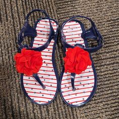 Fourth Of July Sandals Buckles On Side Red Flowers Size- 10c Nwot Blue Open Toe Sandals With Plastic Material, Blue Plastic Sandals For The Beach, Blue Closed Toe Plastic Sandals, Blue Plastic Open Toe Sandals, Blue Open Toe Plastic Sandals, Casual Blue Plastic Sandals, Blue Non-slip Plastic Sandals, Red Round Toe Jelly Sandals For Vacation, Fun Red Open Toe Sandals