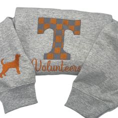 The Tennessee varsity embroidered sweatshirt is made from a cozy cotton poly blend that is perfect for game day. The material is soft and comfortable making it ideal for wearing all day long. The varsity embroidery adds a stylish touch to the sweatshirt making it a great addition to any wardrobe. Whether you're cheering on your team at the game or just hanging out with friends this sweatshirt is sure to keep you warm and looking great. Get yours today and show your team spirit in style! Team-colored Varsity Hoodie For Fall, Game Day Hoodie With Ribbed Cuffs For Fall, Fall Game Day Hoodie With Ribbed Cuffs, Collegiate Sweater For Game Day In Fall, Collegiate Fall Sweater For Game Day, Fall Hoodie With Ribbed Cuffs For Game Day, Varsity Long Sleeve Hoodie For Game Day, Collegiate Style Sweater For Game Day In Fall, Varsity Tops For Fall