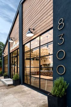 the outside of a restaurant with tables and chairs in front of glass doors that say 3600