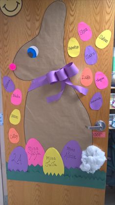 a door decorated with easter eggs and a bunny