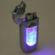 a lighter that is lit up and has a fish in it's mouth on top of the lighter