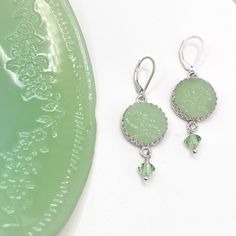 "Jadeite Fire King Earrings, Vintage Jadeite Plate, Jadeite Junkies, Broken China Jewelry, Unique Gifts for Women, Tassel Earrings Artfully repurposed vintage Fire King plate. Sterling Silver. Drop measures 1.50\". 5/8\" round jadeite charm. From top of ear wire to bottom of crystal is 2\" long. Extremely light weight and fluid, they move with you! Our modern make over of this 1940's classic is a must have for every jadeite collector. Charming handcrafted earrings feature this fabulous Alice jad Vintage Jadeite, Broken China Jewelry, Vintage Fire King, China Jewelry, Repurposed Vintage, Broken China, Unique Gifts For Women, Anniversary Jewelry, Cameo Necklace