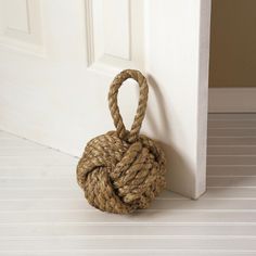 a rope ball hanging on the side of a door