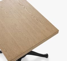 a close up of a wooden table with black legs and an upside down design on the top