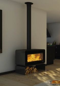 a stove that is in the middle of a living room with wood burning inside it