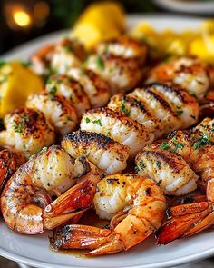 a plate full of grilled shrimp and lemons