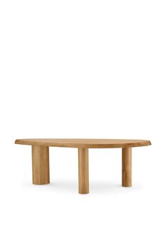 an oval wooden table sitting on top of a white floor