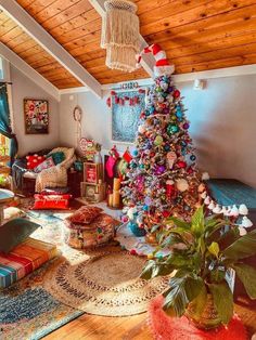 a living room with a christmas tree in the corner and colorful decorations on the walls