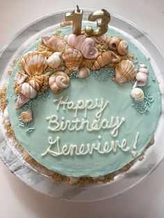 a birthday cake with sea shells and the number five on it's frosting