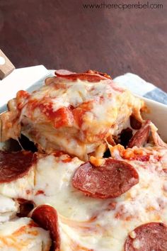 pepperoni and cheese pizza in a white dish