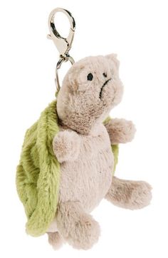 a stuffed animal keychain with a green leaf on it's back, hanging from a metal hook