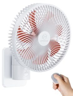 a hand holding a white and red fan