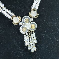 This is part of Chairish’s Costume Jewelry assortment.  1900s Edwardian sterling & crystal necklace. Centerpiece w/ sterling frame supporting faceted crystal discs w/ floral centers, graduated crystal dangles, filigree platforms w/ carved glass rosettes; double strands of graduated crystals w/ sterling separators finished w/ filigree clasp w/ carved crystal rose. Spectacular creation in stunningly excellent condition, it glitters and glistens and gleams. The height of antique elegance and grace, Vintage Adjustable Jewelry For Celebrations, Elegant Vintage Collection Jewelry, Vintage Clear Necklace For Wedding, Vintage Clear Necklaces For Formal Occasions, Vintage Jewelry Bead Caps For Jewelry Making, Vintage Clear Crystal Necklace, Victorian Beaded Jewelry For Vintage Events, Vintage Crystal Pendant Jewelry, Vintage White Crystal Jewelry