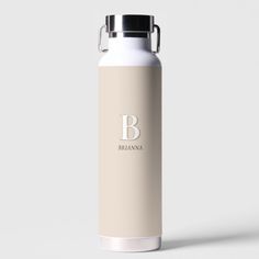 a white water bottle with the letter b on it's side and a black lid